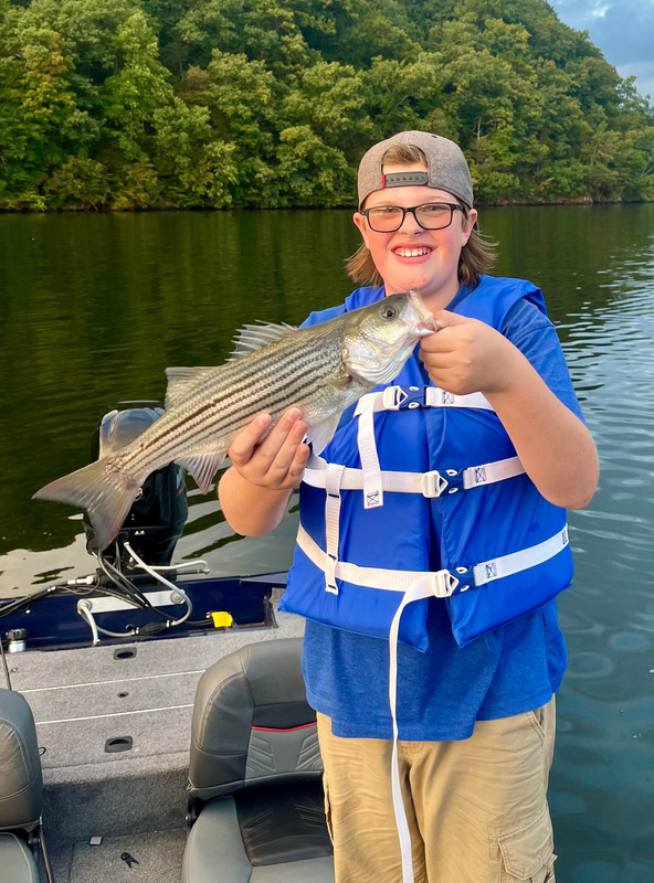 Jesse Roope hold up a nice catch from a recent fishing trip